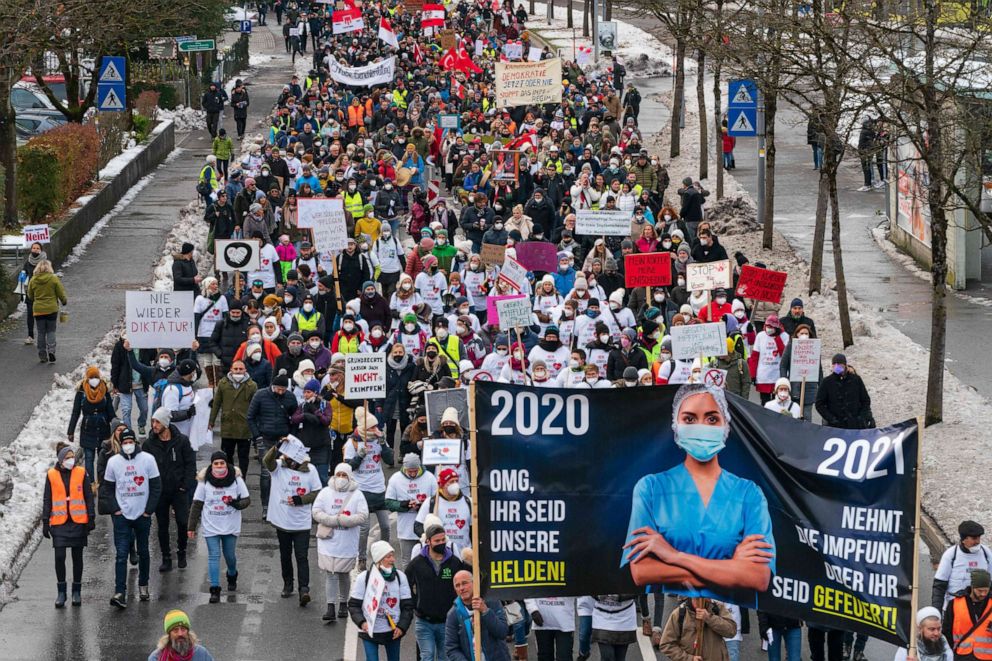 PHOTO: Protesters carry a banner reading "2020: OMG, you are our heroes - 2021: take the vaccination or you are fired" as they take part in a demonstration against the Austrian government's measures taken in order to limit the spread of the coronavirus.