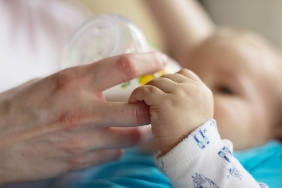 PHOTO: A woman feeds a baby from a bottle in an undated stock photo.