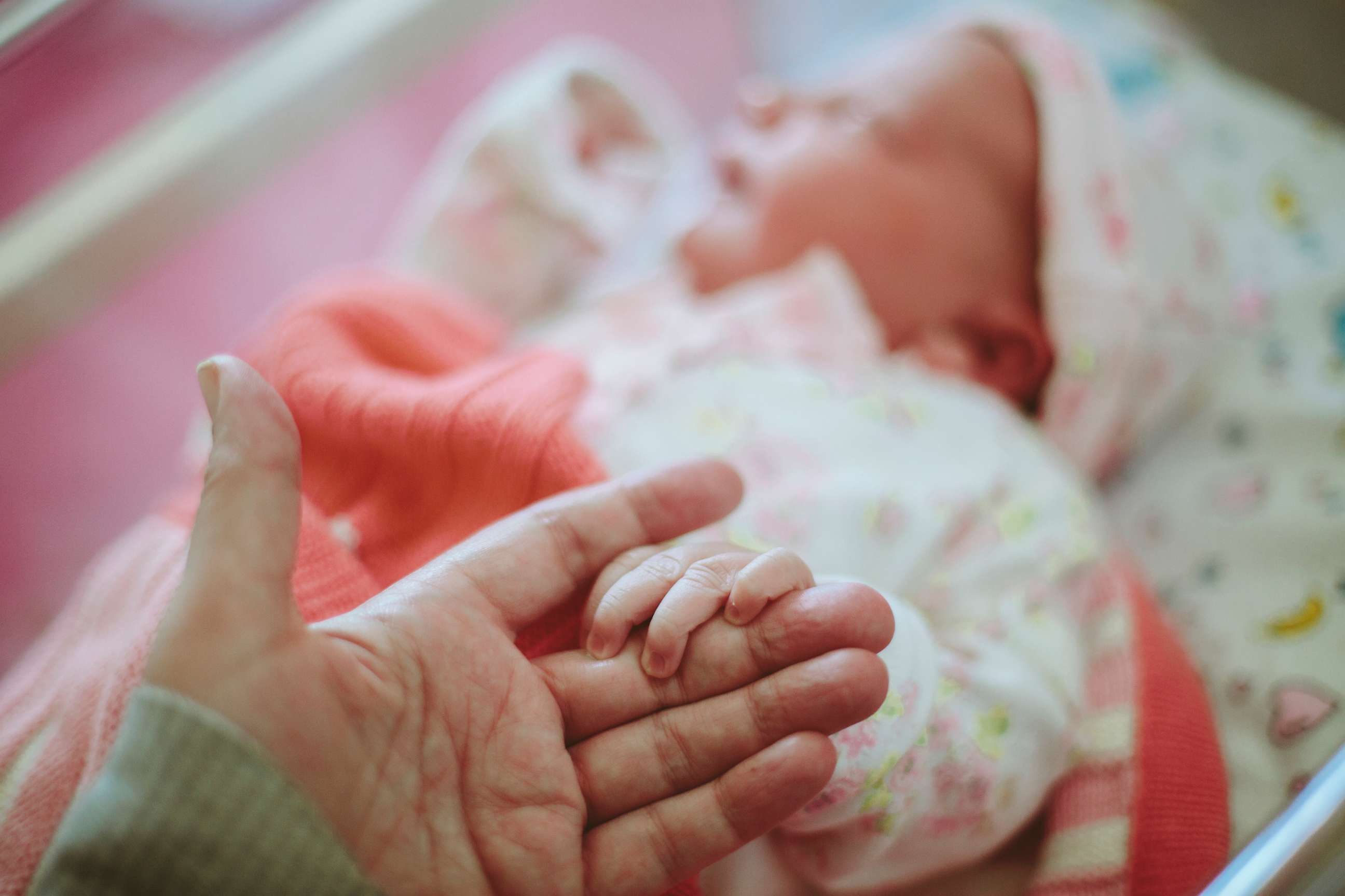 PHOTO: A newborn baby holds a hand in an undated stock photo.