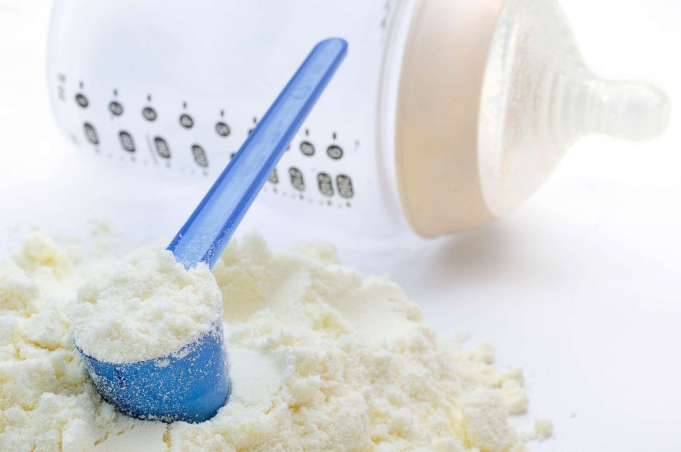 PHOTO: A measuring spoon with baby milk formula and a plastic bottle are pictured in this undated stock photo.