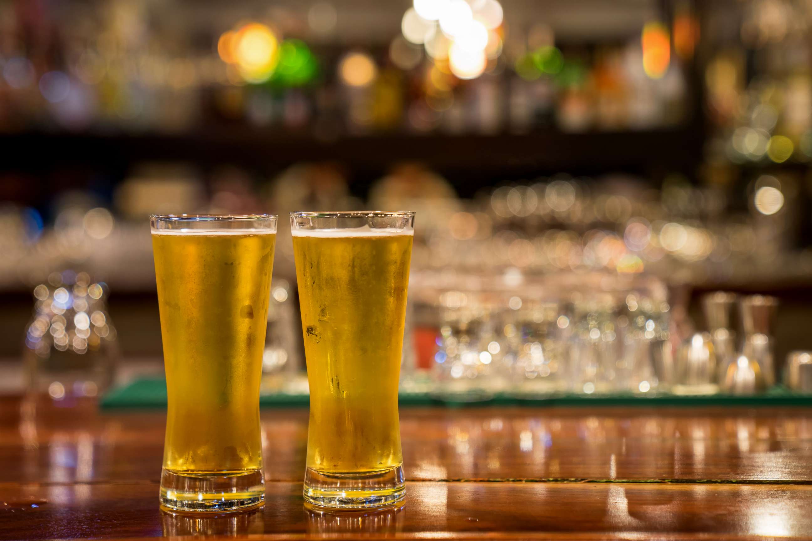 PHOTO: Two glasses of beer sit on a bar in this stock photo.