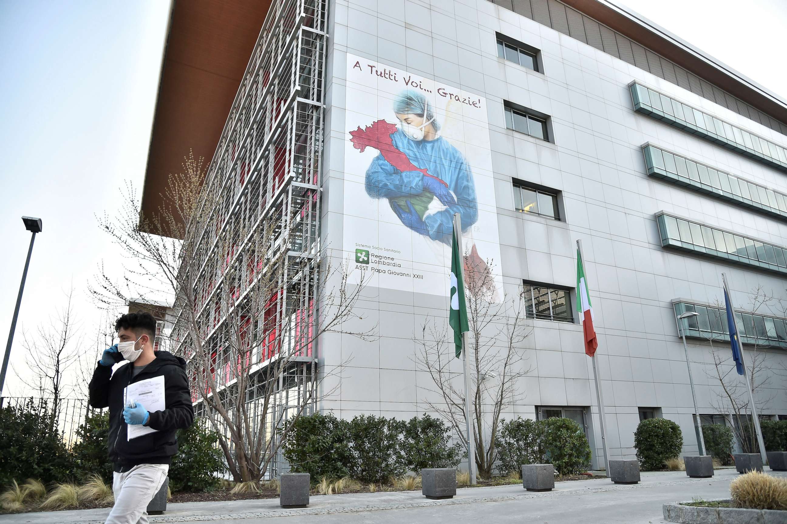 PHOTO: A man walks in front of Bergamo hospital in Bergamo, Italy March 16, 2020.