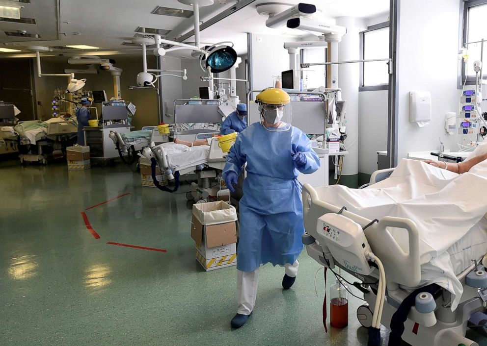 PHOTO: Medical staff member are seen next to patients in the intensive care unit at the Papa Giovanni XXIII hospital in Bergamo, Italy May 12, 2020.
