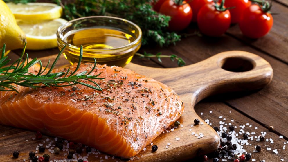 PHOTO: A salmon steak and olive oil are being prepared for cooking in this stock image. 