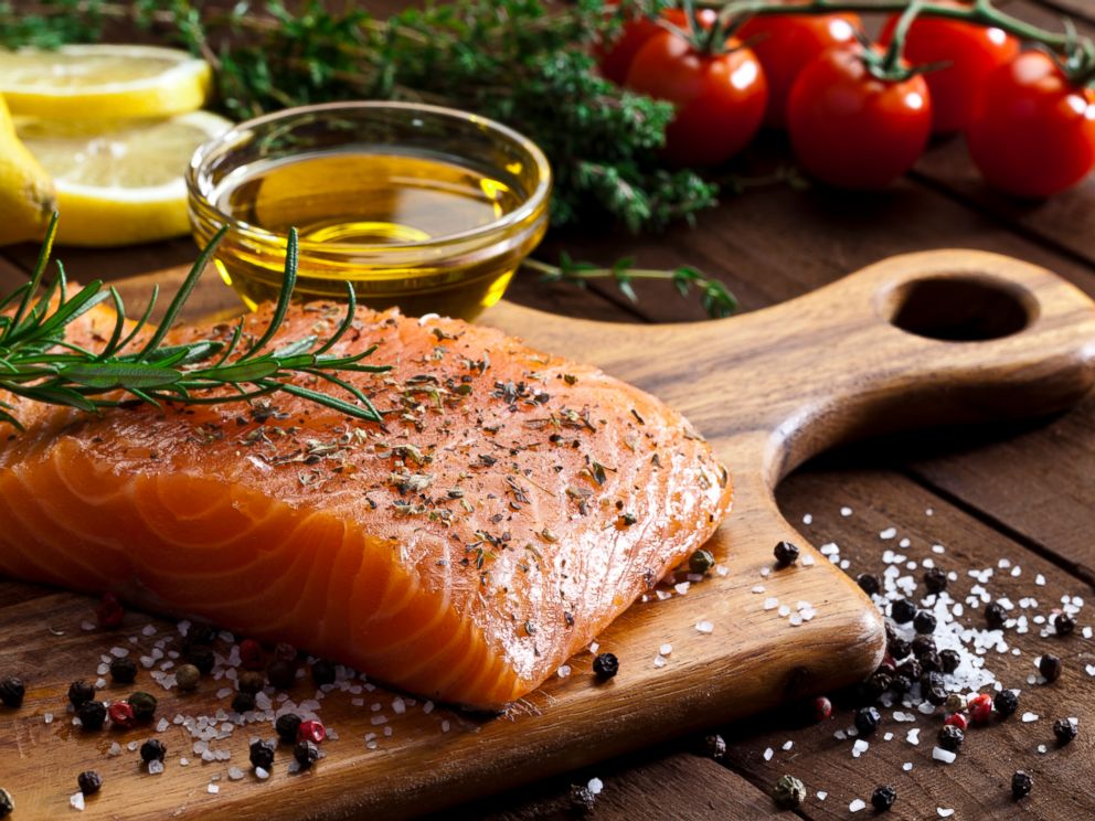 PHOTO: A salmon steak and olive oil are being prepared for cooking in this stock image.