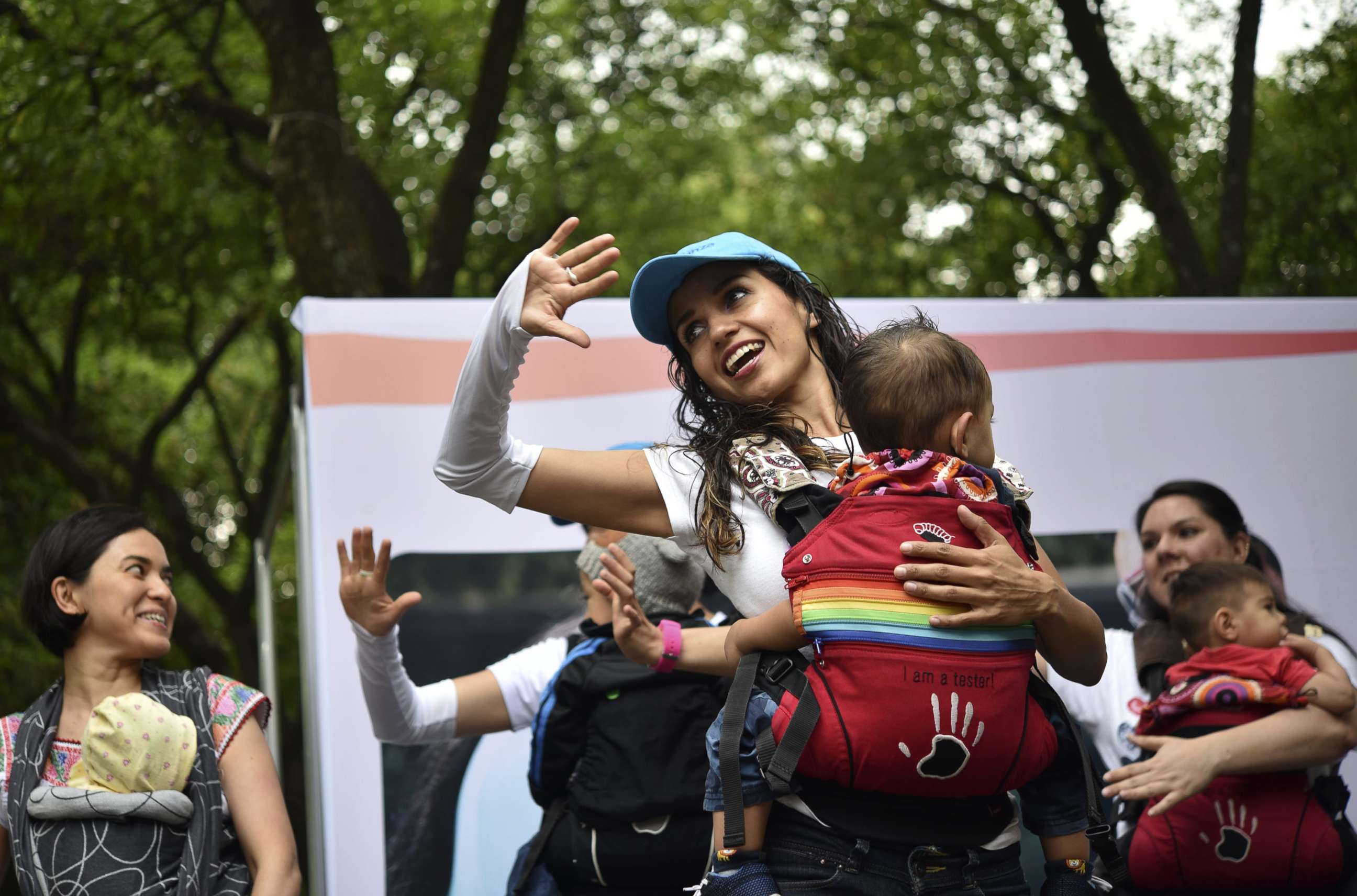 PHOTO: Mothers carrying their children perform during the "Big Latch On" breastfeeding festival held at the Bonatic Garden of the Chapultepec Park in Mexico City on Aug. 5, 2017.