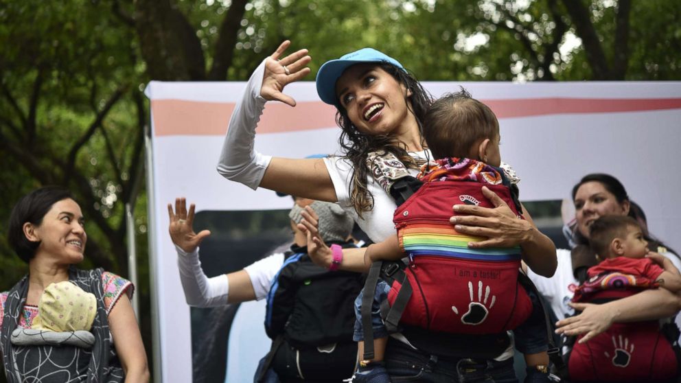 PHOTO: Mothers carrying their children perform during the "Big Latch On" breastfeeding festival held at the Bonatic Garden of the Chapultepec Park in Mexico City on Aug. 5, 2017.