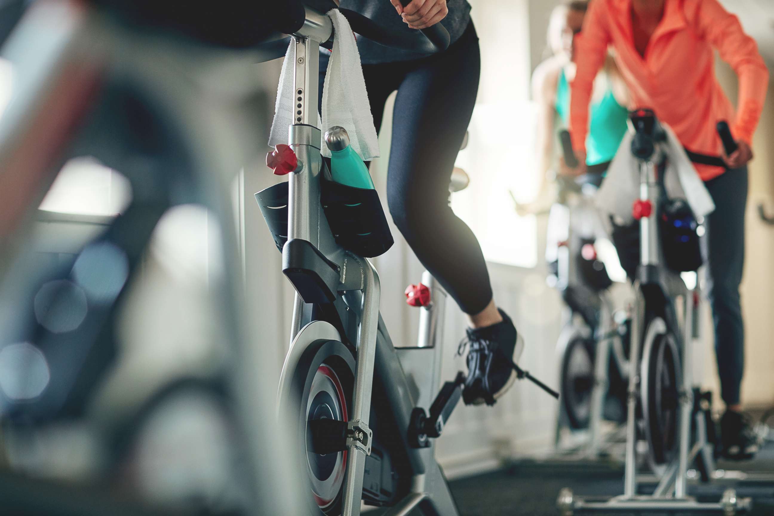 PHOTO: Women work out on exercise bikes at a gym.