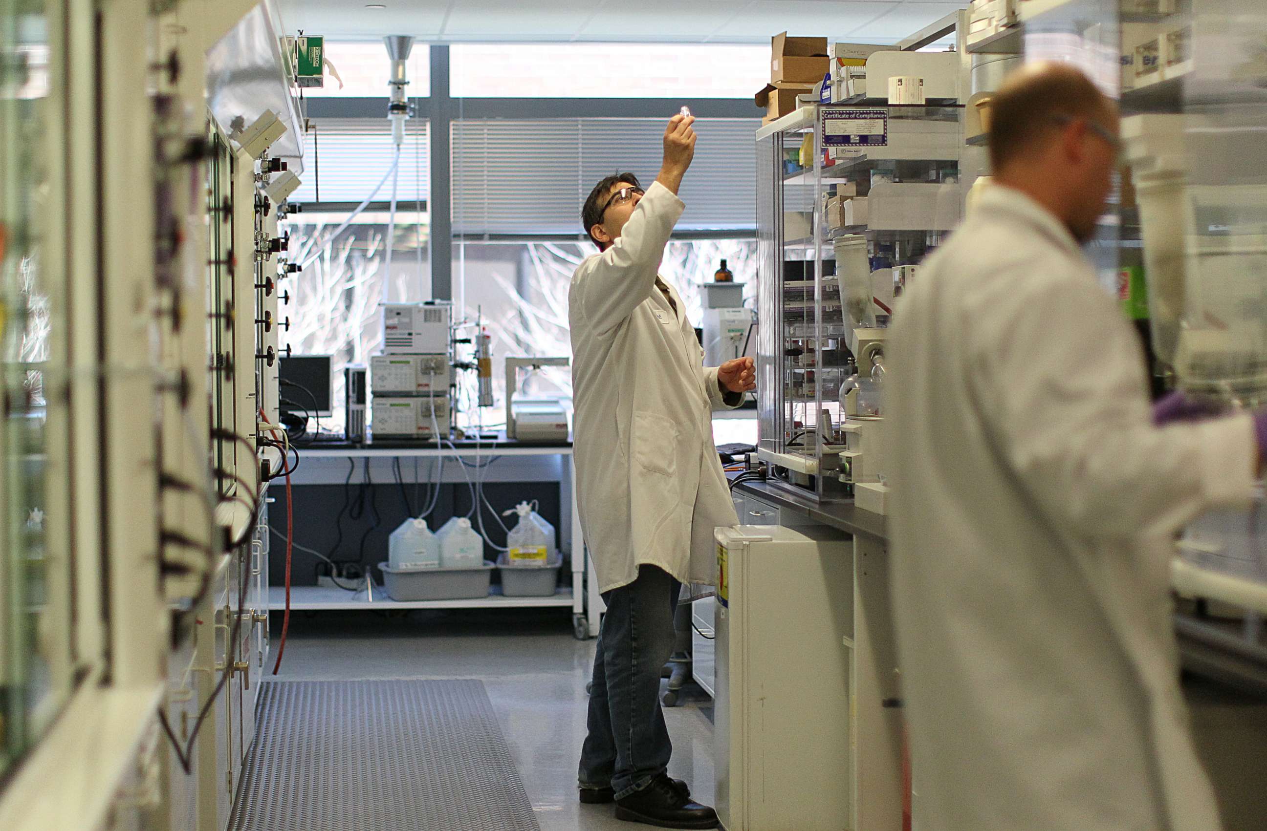 PHOTO: Lab employees work at Biogen Idec in Cambridge, Mass., April 25, 2013.