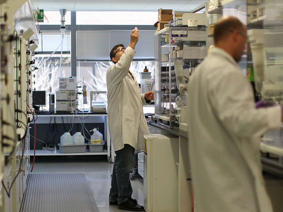 PHOTO: Lab employees work at Biogen Idec in Cambridge, Mass., April 25, 2013.