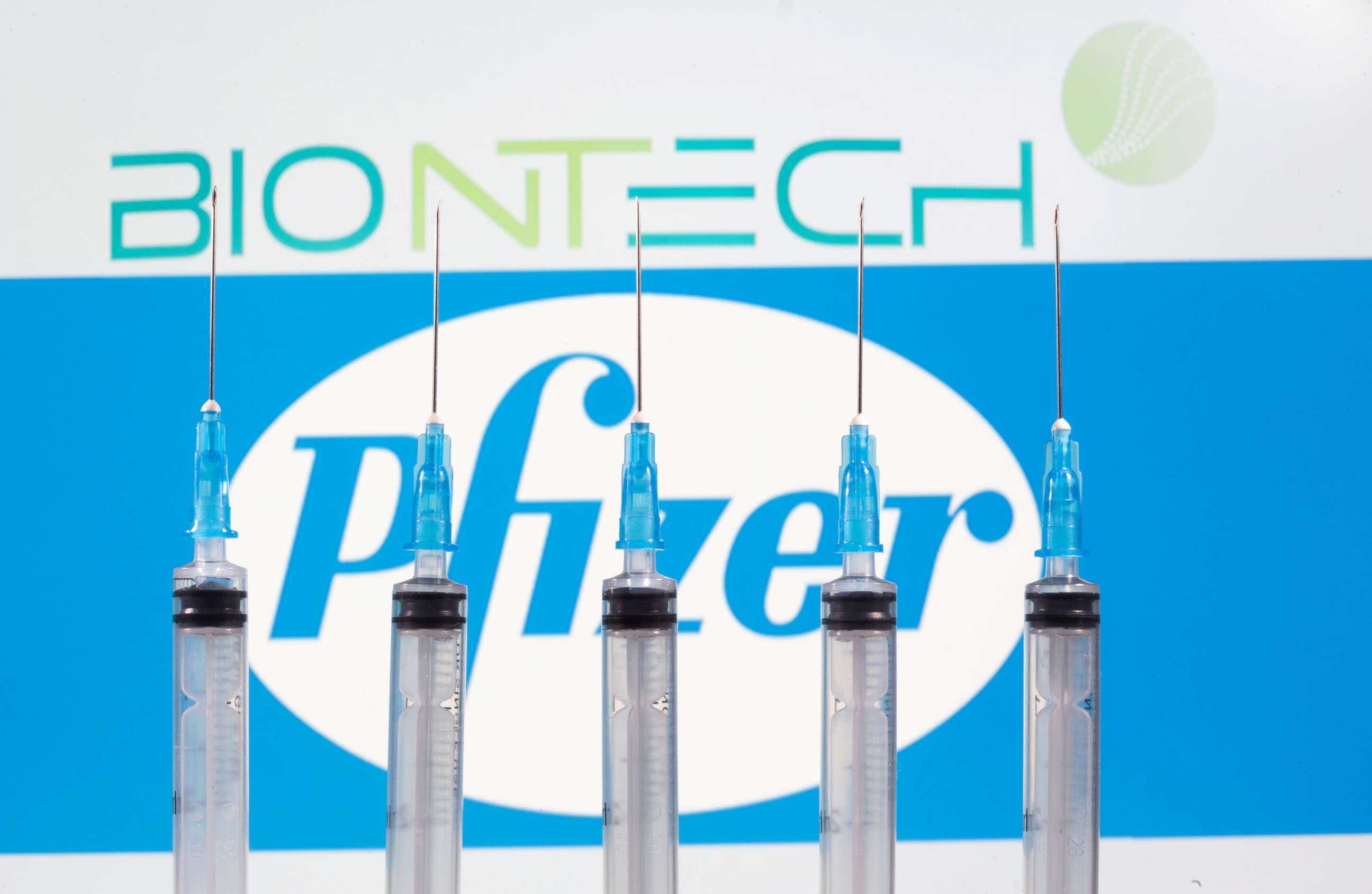 PHOTO: Syringes are seen in front of the displayed logos of BioNTech and Pfizer in this illustration taken on Nov. 10, 2020.