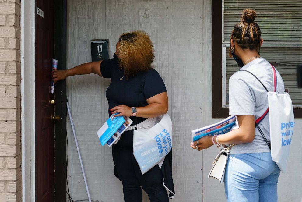 PHOTO: In this June 30, 2021, file photo, volunteers and staffers knock on a door during an outreach effort to inform residents about an upcoming COVID-19 vaccination event in Birmingham, Ala.