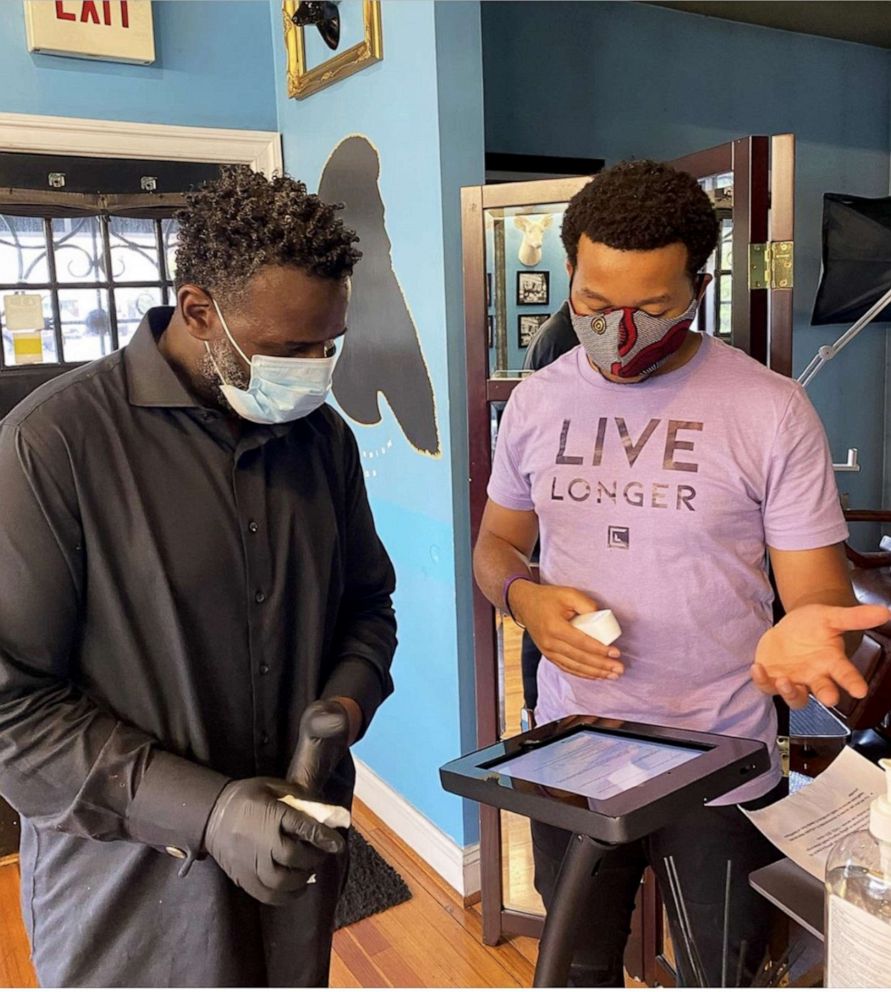 PHOTO: Live Chair Health CEO and Co-Founder Andrew Suggs teaches Millennium Salon owner Dexter FIelds of Silver Spring, Maryland how to operate Live Chair Health's check-in kiosk.