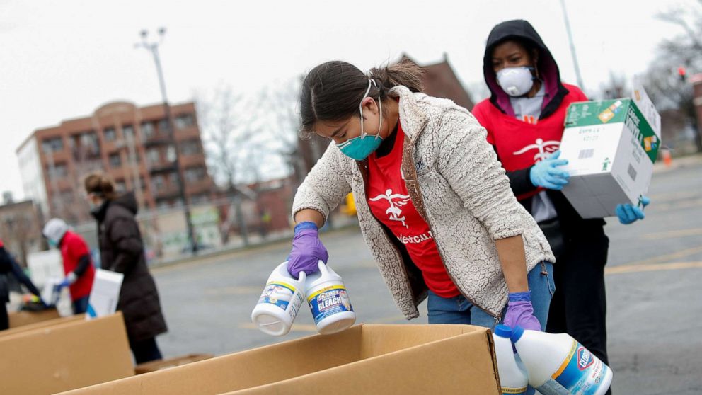 PHOTO: Volunteers with Project C.U.R.E. accept bleach and protective equipment (PPE) from a motorist to be donated to healthcare workers treating coronavirus disease (COVID-19) in Chicago, March 29, 2020. 