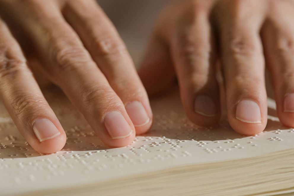 PHOTO: A blind person reads braille.