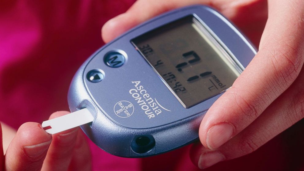 PHOTO: A woman uses a blood glucose measurement to check her blood.