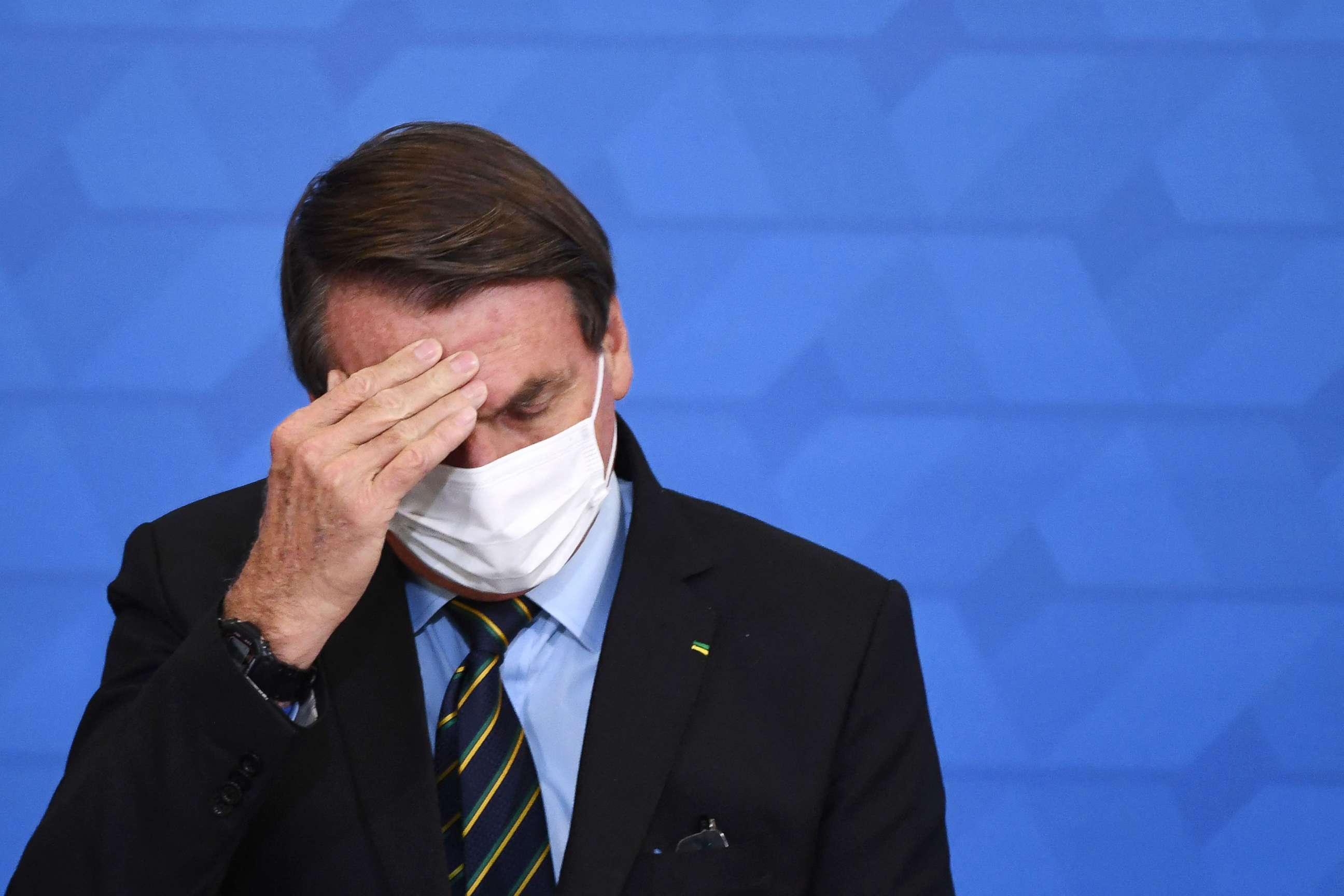 PHOTO: Brazil President Jair Bolsonaro gestures as he speaks during the announcement of support measures to philanthropic hospitals in the fight against the novel coronavirus disease, COVID-19, at Planalto Palace in Brazil, March 25, 2021.