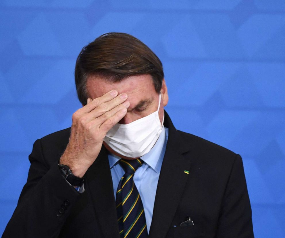 PHOTO: Brazil President Jair Bolsonaro gestures as he speaks during the announcement of support measures to philanthropic hospitals in the fight against the novel coronavirus disease, COVID-19, at Planalto Palace in Brazil, March 25, 2021.