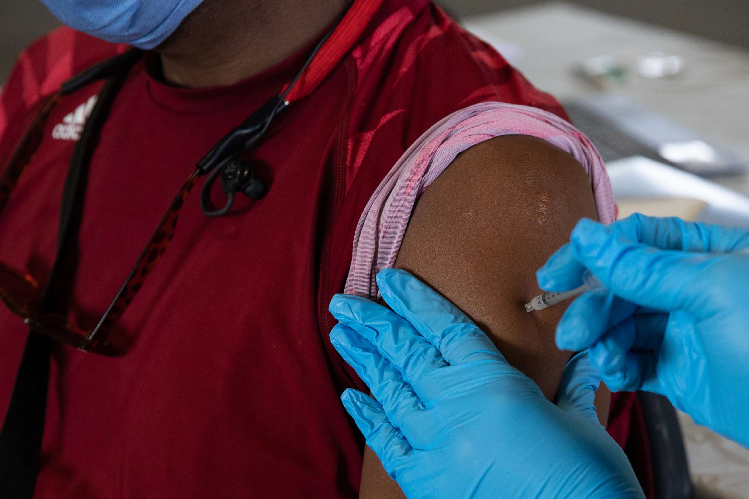 PHOTO: A patient receives his booster dose of the Pfizer-BioNTech coronavirus vaccine during an Oakland County Health Department vaccination clinic at the Southfield Pavilion on Aug. 24, 2021 in Southfield, Mich.