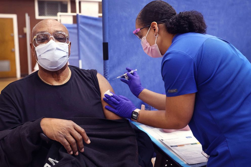 PHOTO: Shana Alesi administers a second COVID-19 booster shot to Army veteran Robert Hall, April 1, 2022 in Hines, Ill.