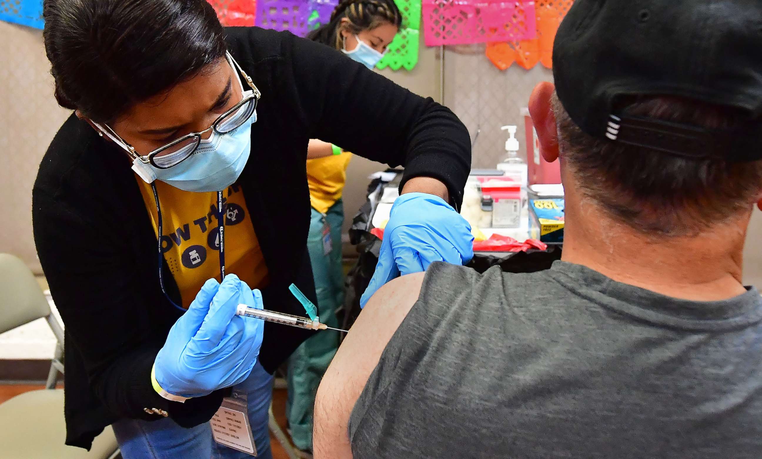 PHOTO: Registered Nurse Mariam Salaam administers the Pfizer booster shot at a COVID-19 vaccination and testing site in Los Angeles, May 5, 2022.