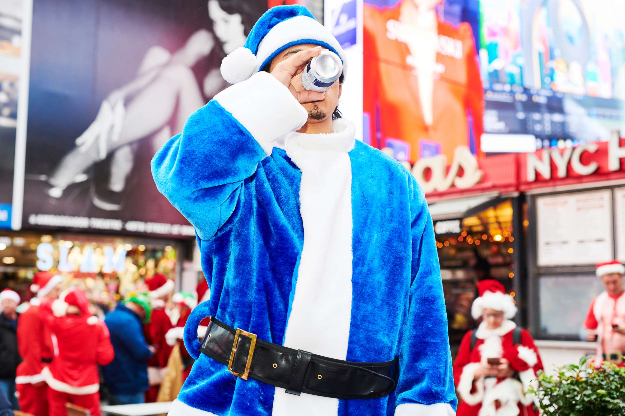PHOTO: A person dressed as Santa Claus drinks a beer at Father Duffy Square for SantaCon on Dec. 14, 2019 in New York City. Every year, people dress up as Santa Claus or in other holiday-themed costumes and drink at multiple bars across the city.