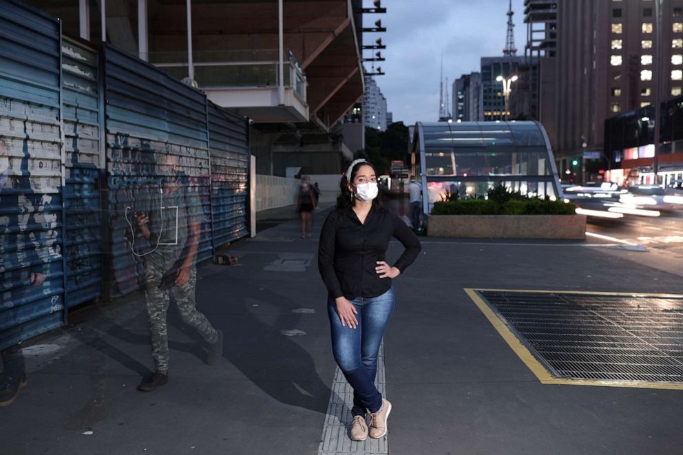 PHOTO: Arianna Cavalcante, 28, a dental surgeon and a volunteer in a COVID-19 vaccine trial for AstraZeneca, poses for a photograph in Sao Paulo, Brazil, Dec. 09, 2020.