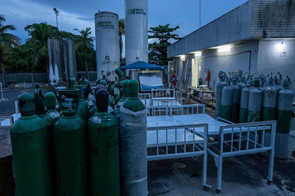 PHOTO: Staff work on the grounds of a hospital called, "August 28" in Manaus, Brazil, March 29, 2021.