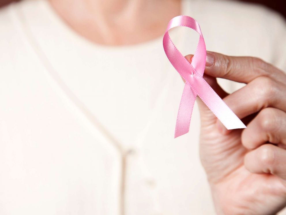 PHOTO: In this undated stock photo, a woman wearing a pink sweater holding a pink breast cancer ribbon.