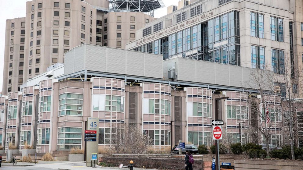 PHOTO: A pedestrian walks past the Brigham and Women's Hospital in Boston, Massachusetts, March 12, 2020.