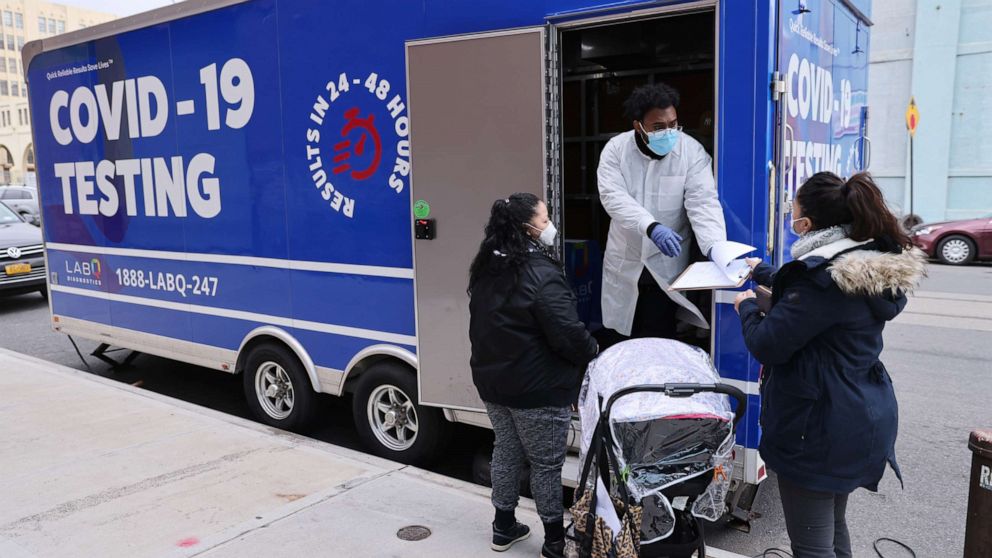 PHOTO: In this Jan. 22, 2021, file photo, a medical worker stands outside of a mobile COVID-19 testing lab in Brooklyn as the city begins to run low on the vaccine doses in New York.