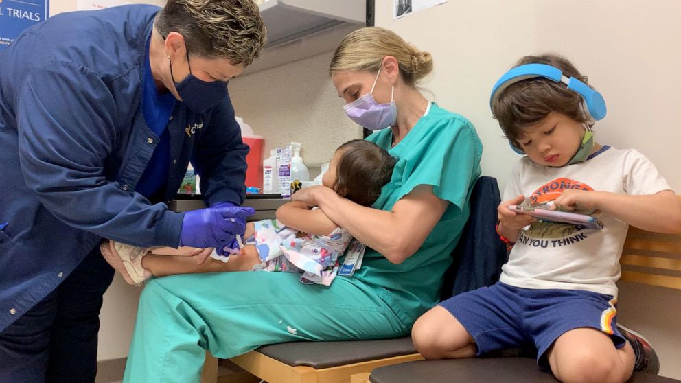 PHOTO: Dr. Erin Biro holds her daughter while she gets a shot for a Pfizer COVID-19 vaccine trial for young children at Ochsner Hospital for Children in Jefferson, Louisiana. Biro's three children are participating in the trial.