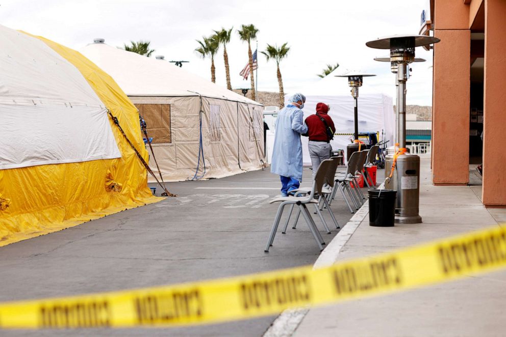 PHOTO: A patient is helped into the emergency room as St Mary Medical Center resorts to using triage tents outside to handle the overflow at its 200 bed hospital during the outbreak of the coronavirus disease in Apple Valley, Calif., Dec. 8, 2020.