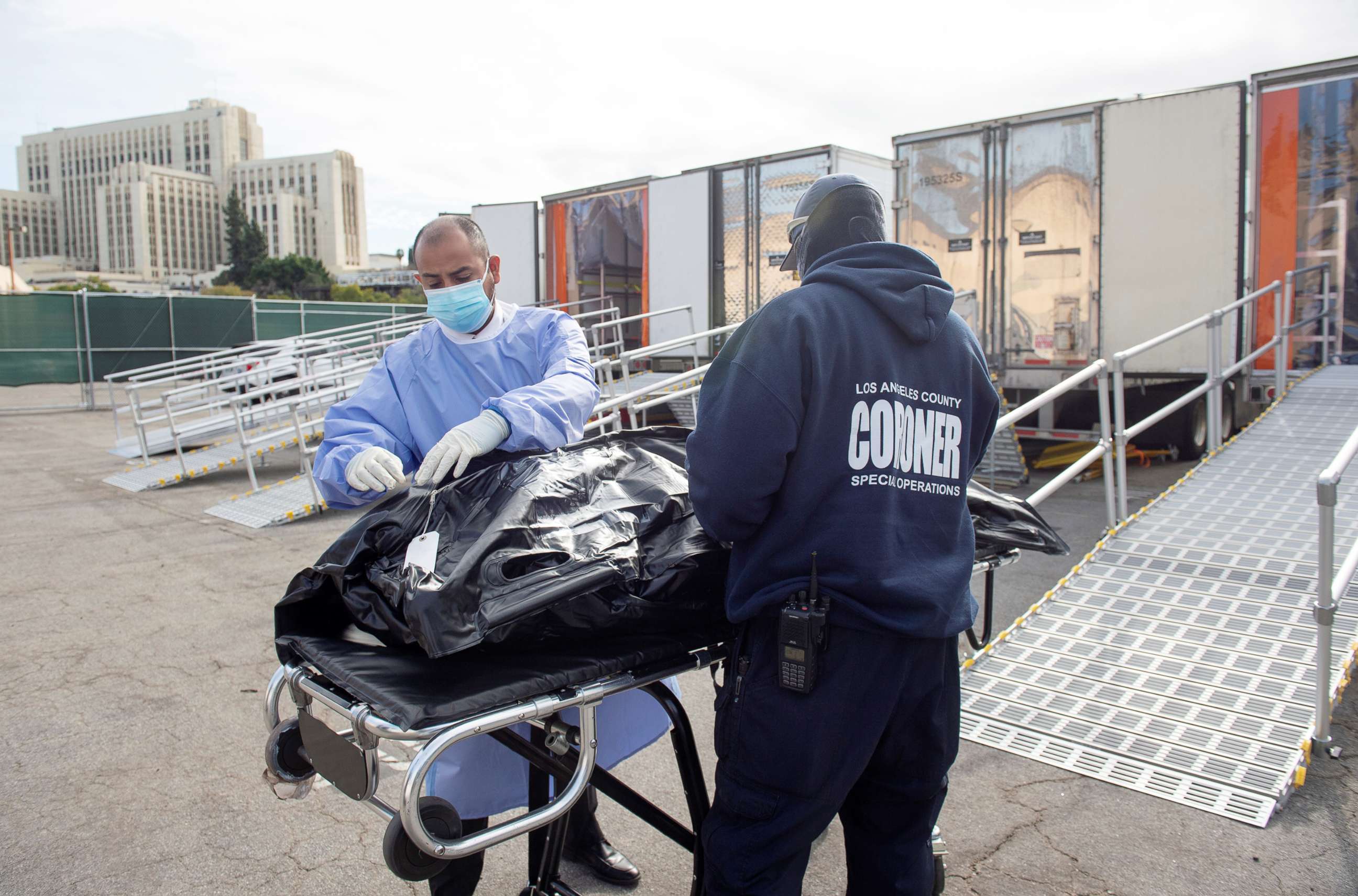 PHOTO: L.A. County Medical Examiner-Coroner personnel prepare to load a container at a  temporary refrigerated storage facility for COVID-19 decedents in Los Angeles,  Jan. 27, 2021. 