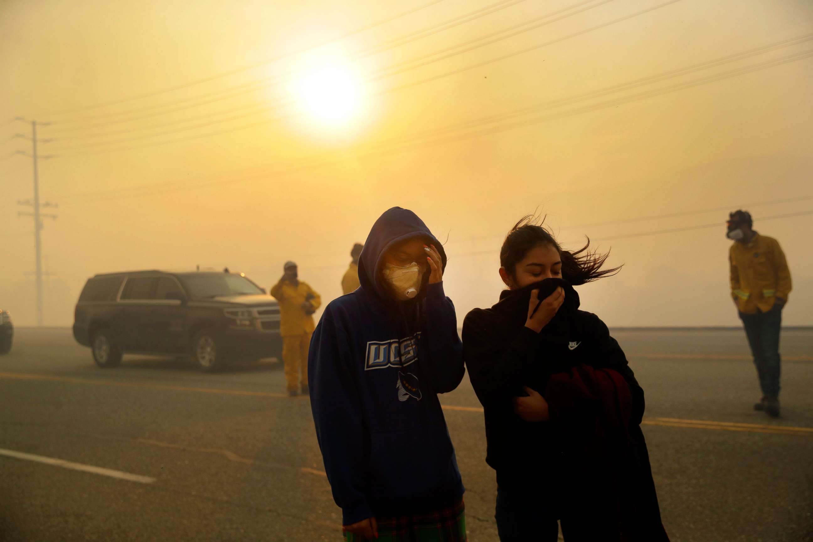 PHOTO: People cover their faces from the smoke created by the Easy Fire, Oct. 30, 2019, in Simi Valley, Calif. 