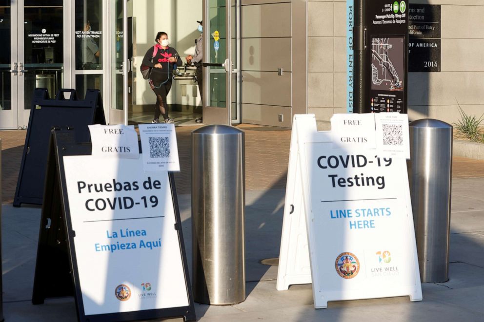 PHOTO: Signs for COVID-19 testing face travelers entering the United States from Mexico at the San Ysidro pedestrian border as San Diego County, in San Diego, Calif., Aug. 14, 2020.      