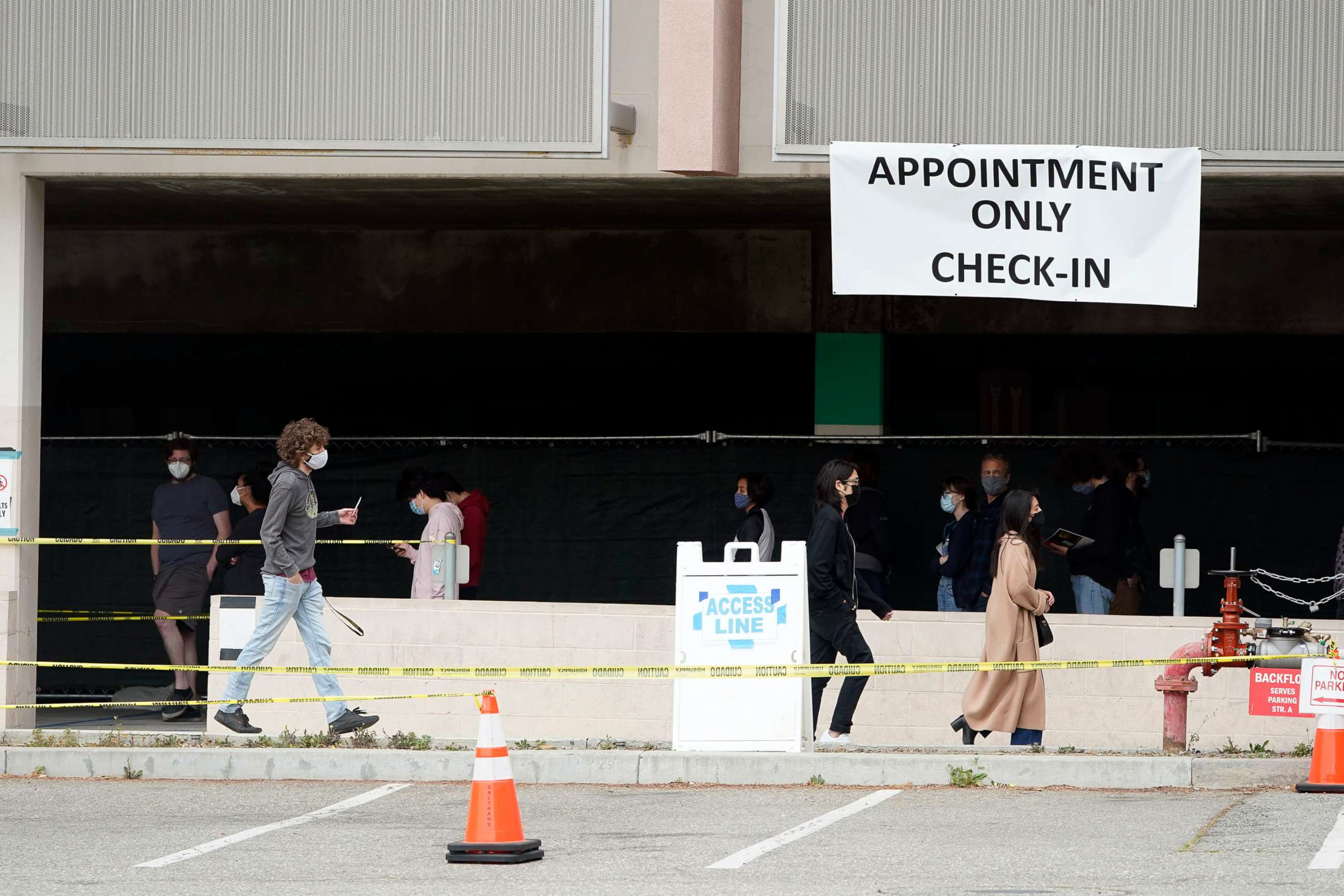 PHOTO: People line up to receive a COVID-19 vaccine, April 13, 2021, on the campus of Cal State LA in Los Angeles. 