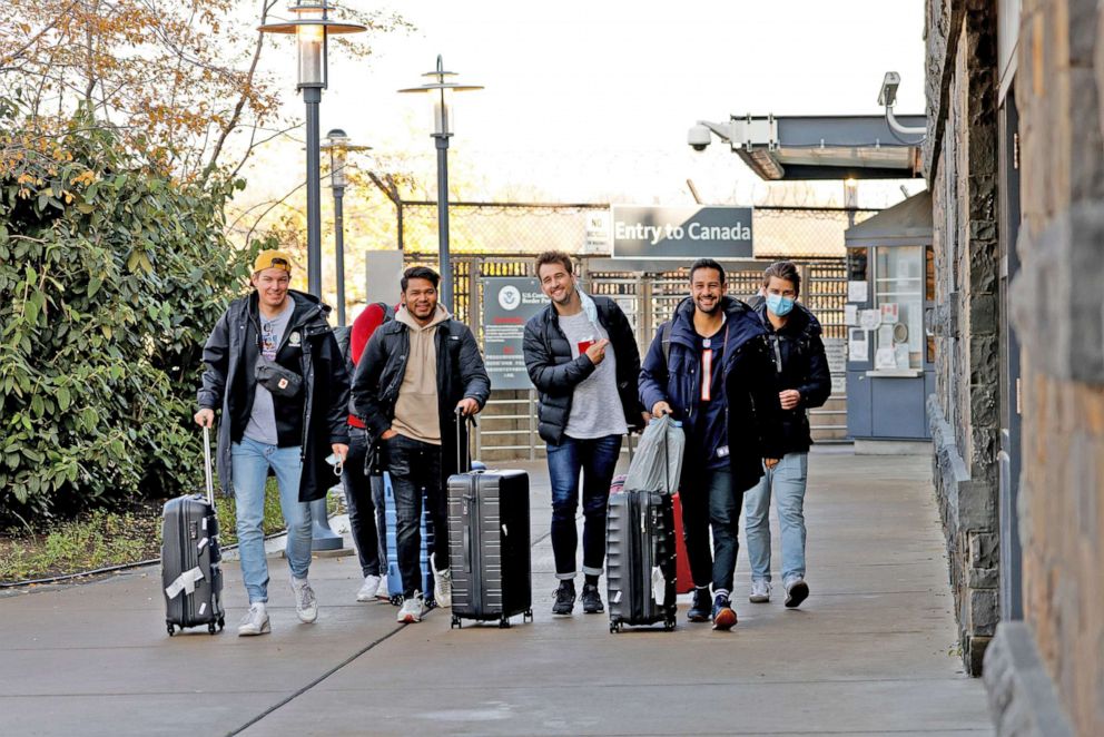 PHOTO: Tourists who crossed the Rainbow bridge by foot enter the U.S. from Canada, as the U.S. reopens air and land borders to fully vaccinated travellers for the first time since COVID-19 restrictions were imposed, in Niagara Falls, N.Y., Nov. 8, 2021. 