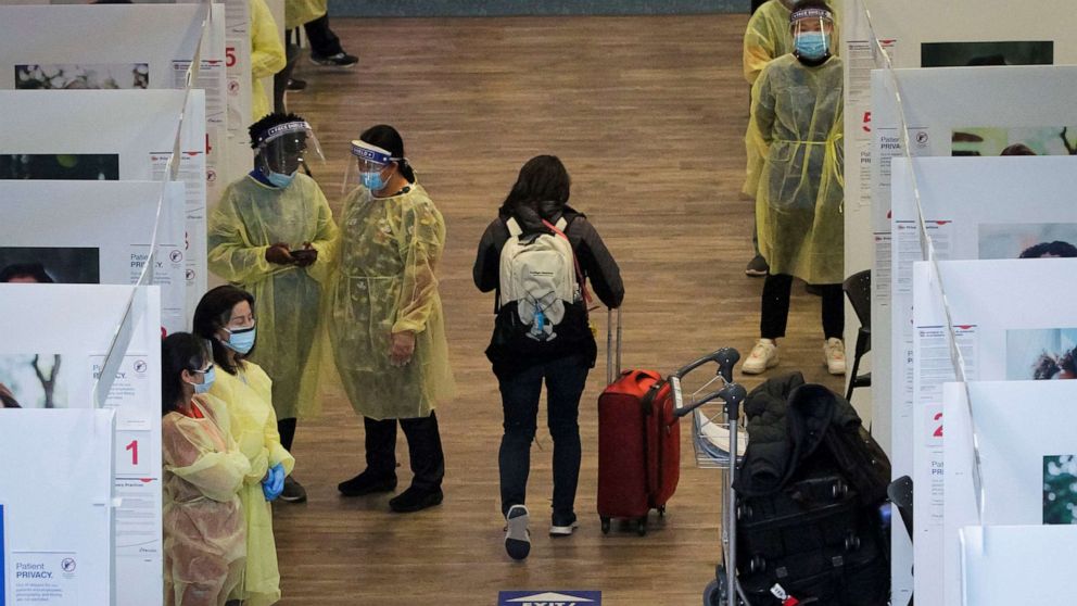 PHOTO: Medical workers attend to travelers at the COVID-19 testing site inside the arrival hall of Vancouver International Airport in Richmond, British Columbia, Canada,  Feb. 15, 2022. 