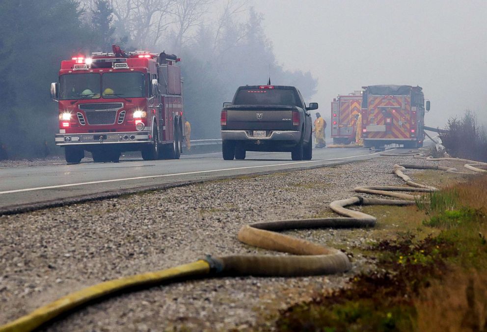 PHOTO: Hose is laid down a road while firefighters tackle the Shelburne wildfires in Shelburne County, Nova Scotia, Canada, June 2, 2023.