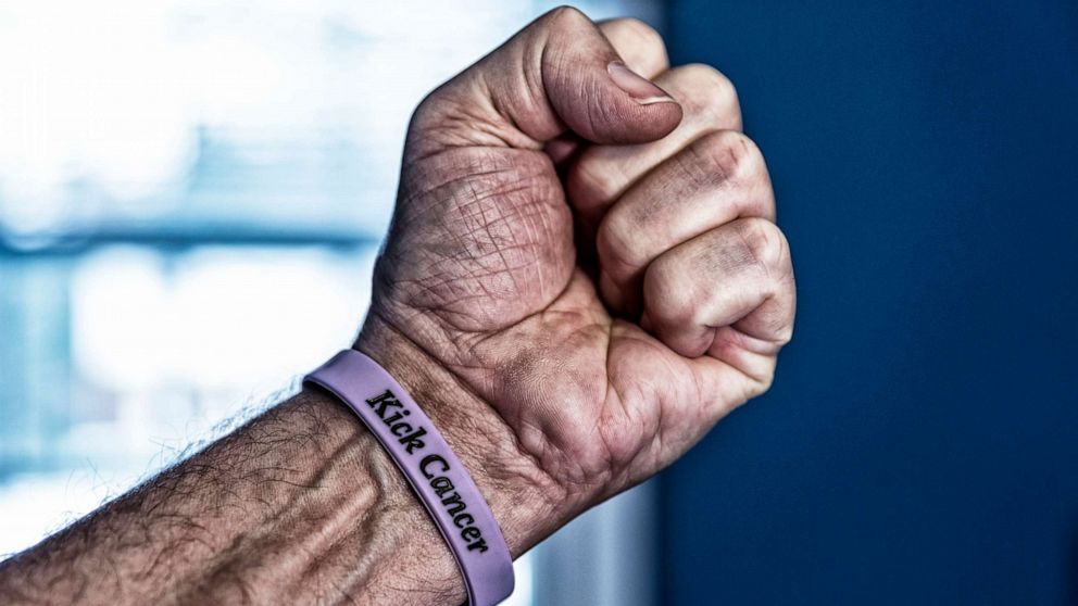 PHOTO: Photo of a fist with a cancer bracelet. 