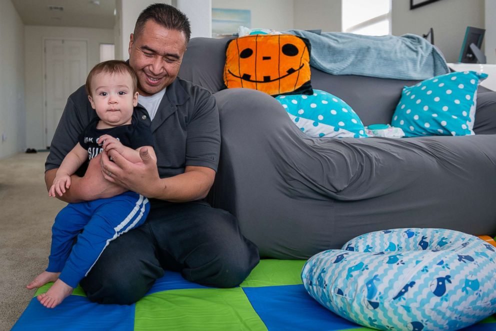 PHOTO: Robert Cano plays with his 10-month-old son, Brody, before leaving for work.