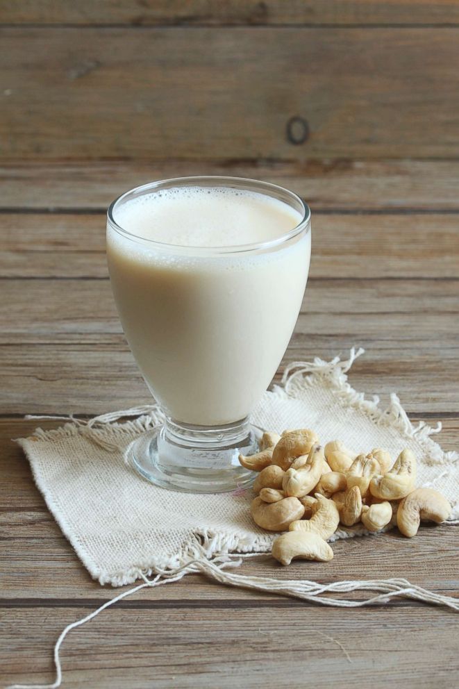 PHOTO: A glass of cashew nut milk with cashew nuts.