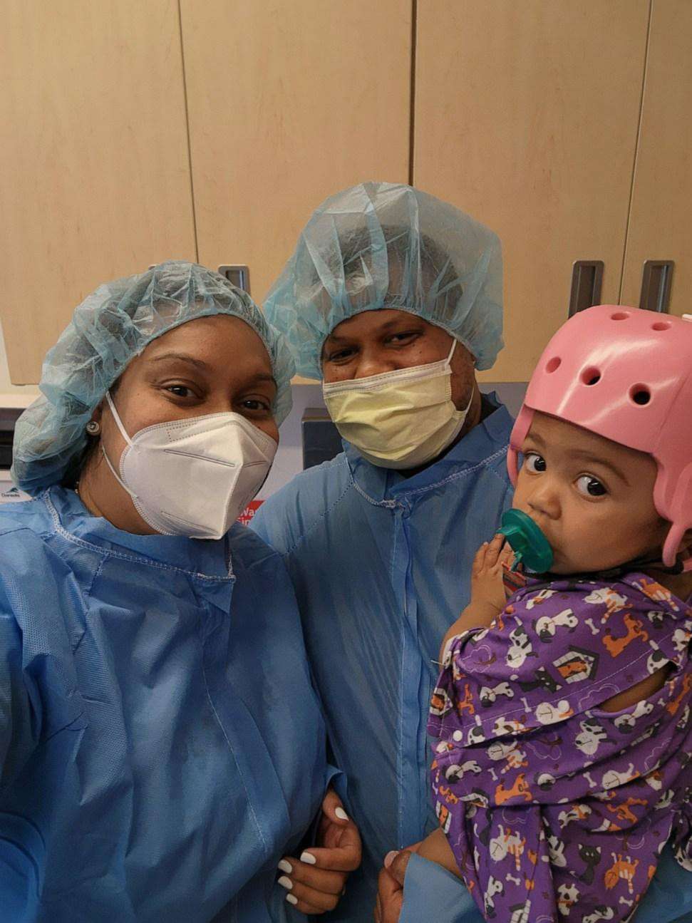 PHOTO: Miraida Gomez, Gregory Arias and Catherine before her cranioplasty in April 2022.