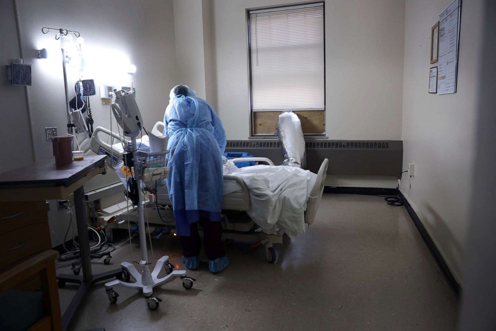 PHOTO: Kennedy Rutland gets vital information from a COVID-19 patient at Roseland Community Hospital, Dec. 17, 2020, in Chicago.