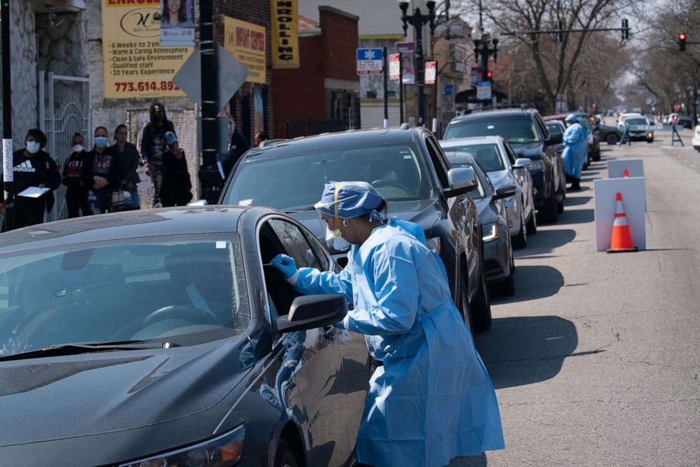 PHOTO: People wait in line in their cars to get tested for COVID-19 at Roseland Community Hospital, April 3, 2020, in Chicago.