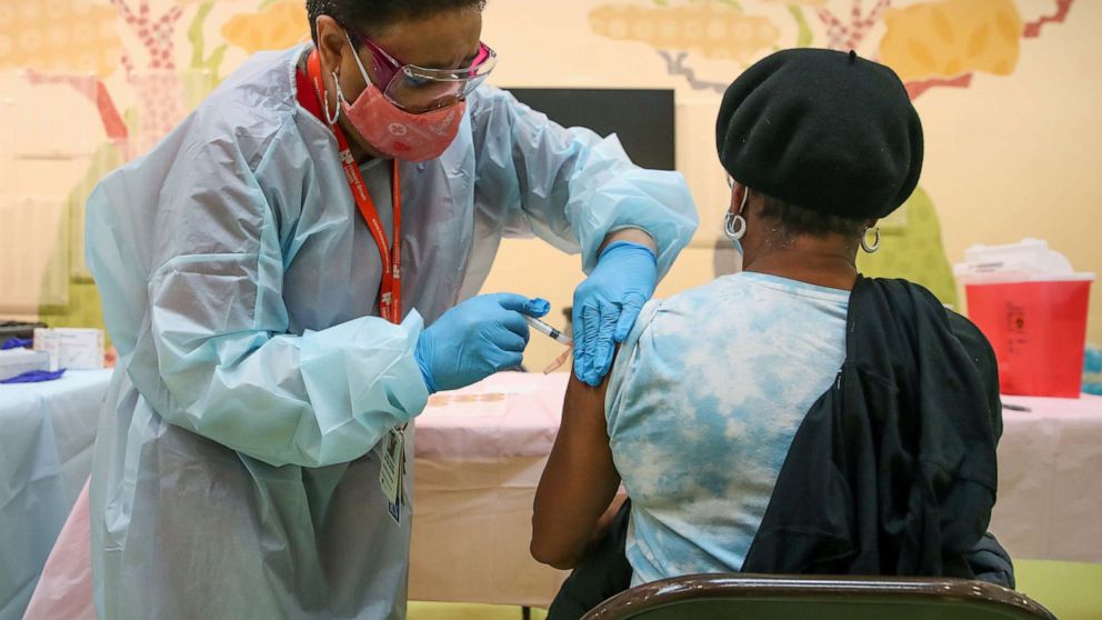 PHOTO: A woman receives the Moderna coronavirus disease (COVID-19) vaccination shot from nurse Kathy McLoyd at Trinity United Church of Christ in Chicago, Feb. 13, 2021. 