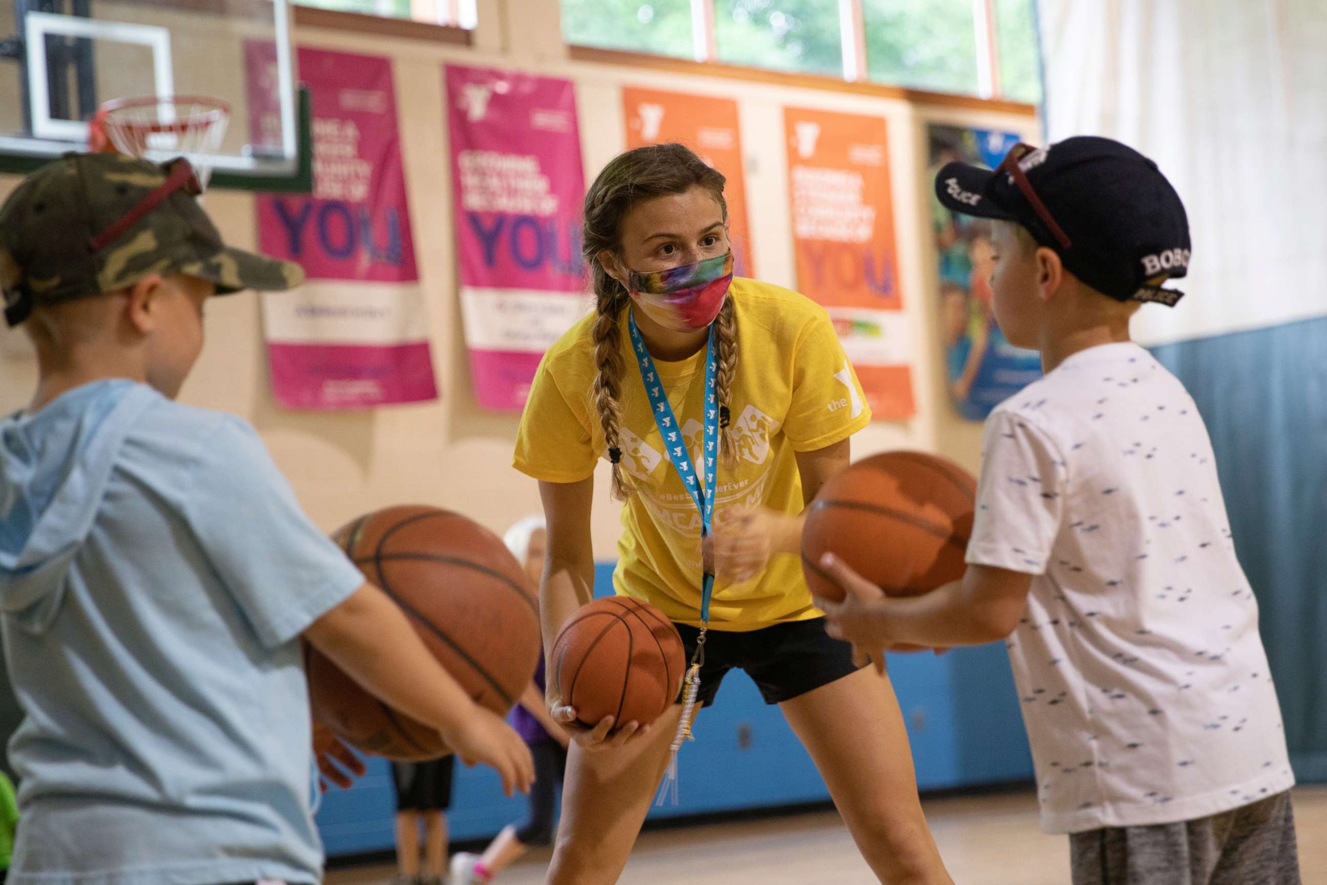 PHOTO: A counselor wearing a protective face mask plays with children as summer camps reopen amid the spread of COVID-19 at Carls Family YMCA summer camp in Milford, Mich., June 23, 2020.