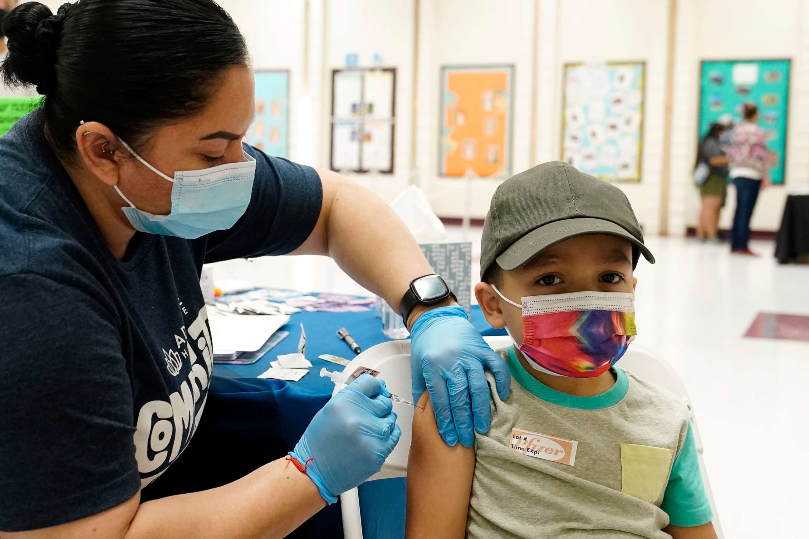 FILE PHOTO: Oliver Estrada, 5, right, receives the first dose of Pfizer's COVID-19 vaccine from medical assistant Patricia Munoz at an Adelante Healthcare community vaccine clinic at Joseph Zito Elementary School in Phoenix, Arizona, on Nov. 6, 2021.