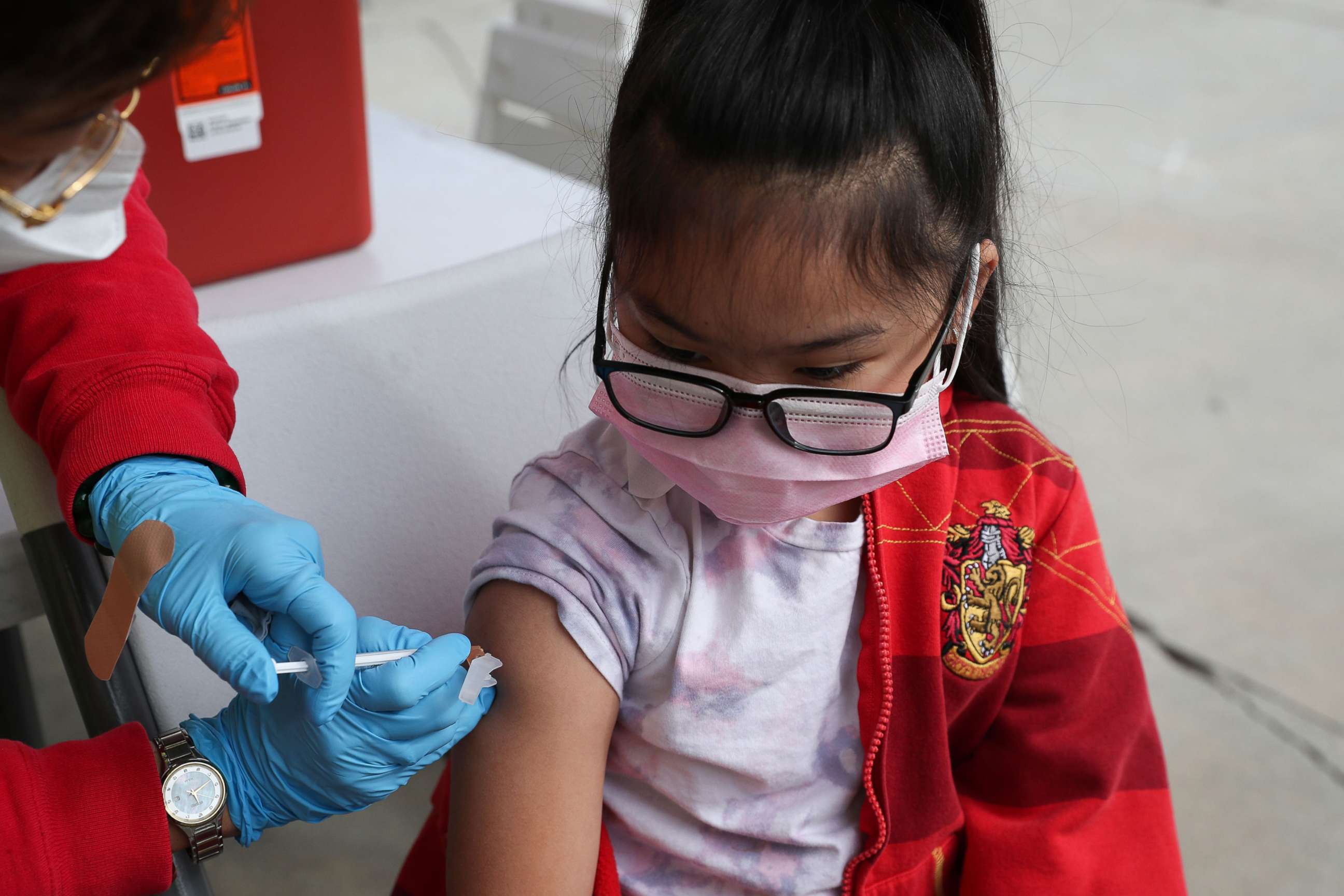 PHOTO: A 6-year-old girl receives a dose of the Pfizer BioNTech COVID-19 vaccine at a vaccination site at Lincoln Park Recreation Center in Los Angeles, Dec. 21, 2021.